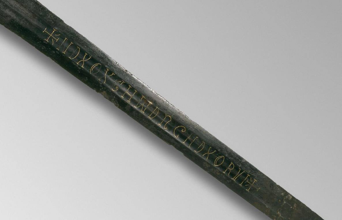 Close-up of the gold wire inscription on the Witham Sword blade reading +NDXOXCHWDRGHDXORVI+